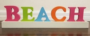 Wooden multicolored "BEACH" sign